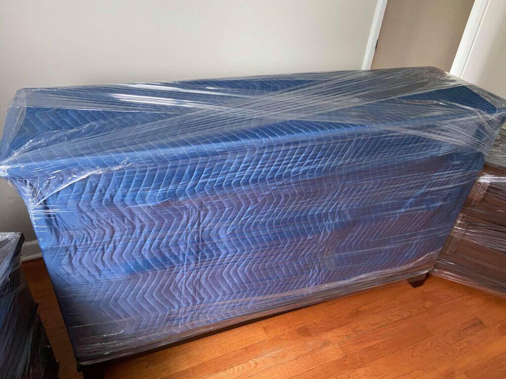 Moving furniture items with blankets and shrink-wrap